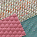 Verschiedene Stoffmuster für Sofas, darunter ein gepunkteter rosa Stoff, ein strukturierter türkisfarbener Stoff und ein bunt gemusterter Stoff mit Multicolor-Fäden – harmonische Kombination für individuelles Möbeldesign