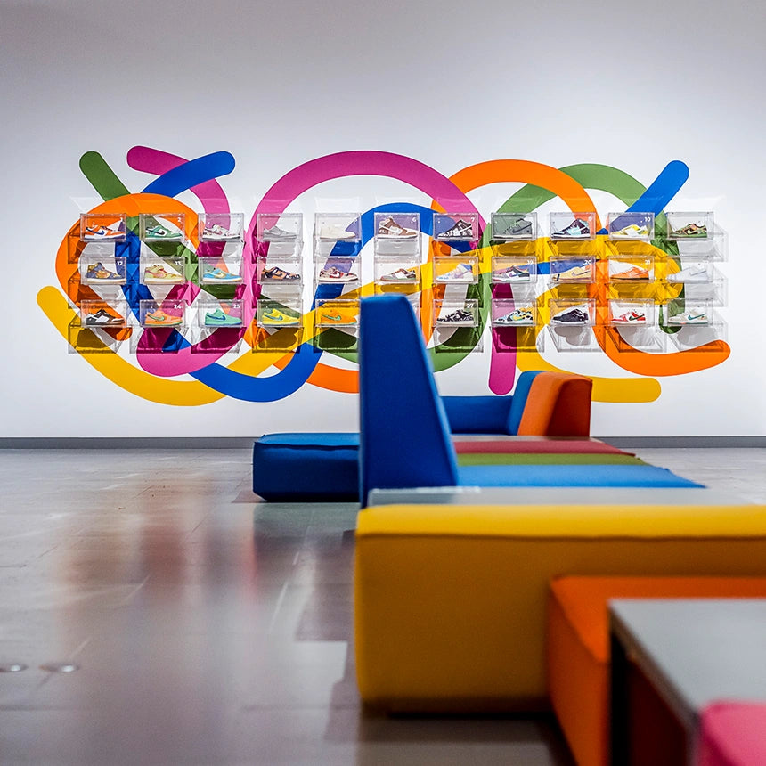 Colorful Cubit sofa modules in a colorful showroom with wall graphics and sneaker showcases, designed as contract furniture for visitor areas
