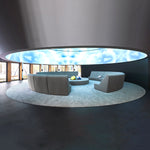 Spacious seating landscape with modular contract furniture in a round room with a circular light dome
