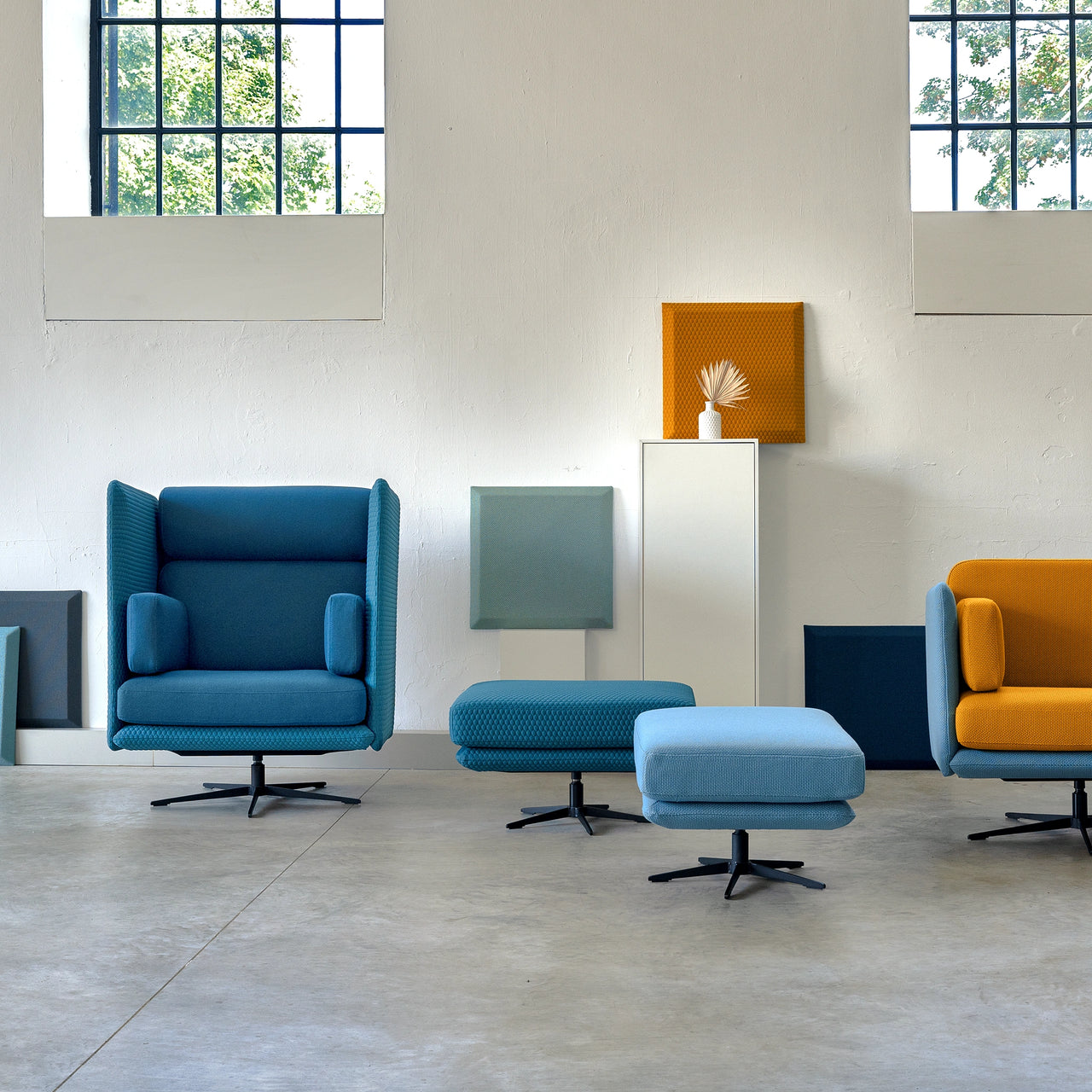Custom-made lounge chairs with stools as part of a contract order - stylish presentation in the showroom