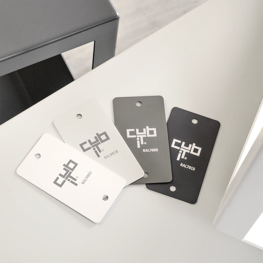 Four Cubit Lacquer samples in white, light grey, medium grey and anthracite on coffee table to choose from