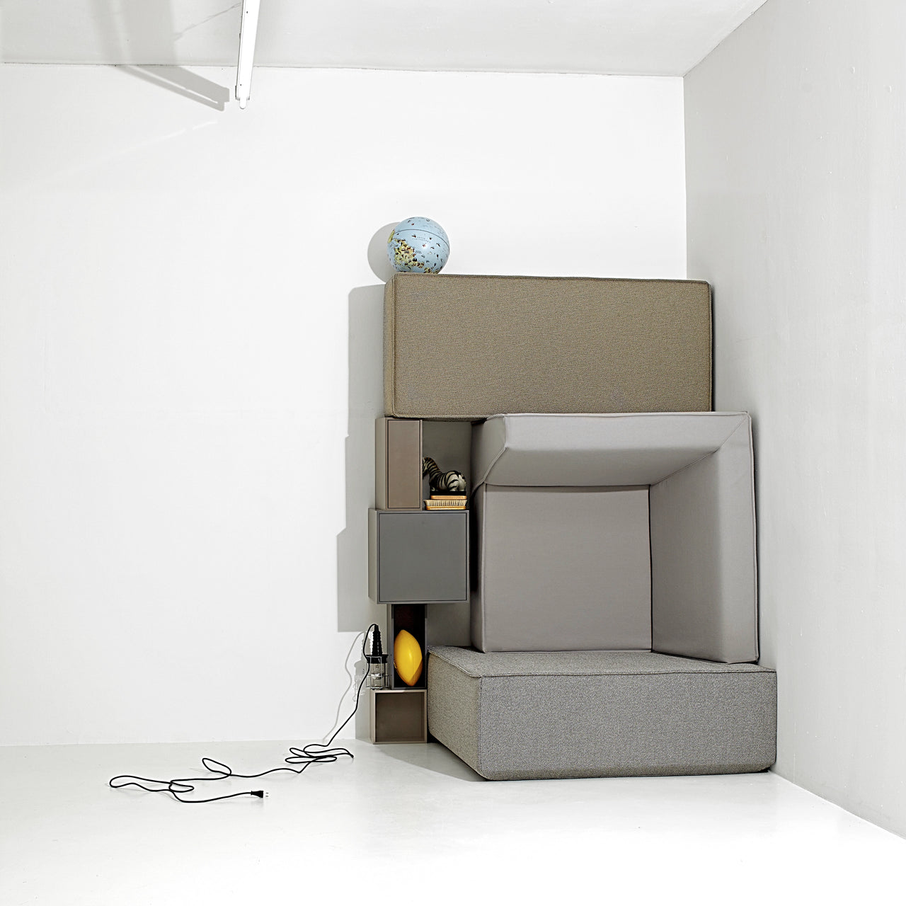 Artistically staged structure consisting of Cubit sofa modules and Cubit shelf modules - not intended for use