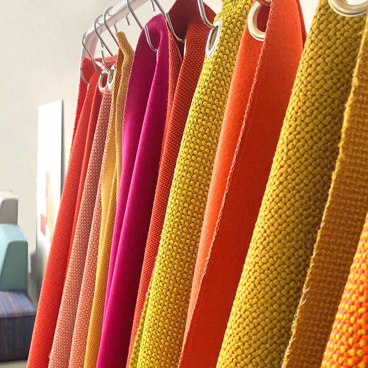 Selection of fabric samples in warm colors, symbolic of sustainable materials at Cubit