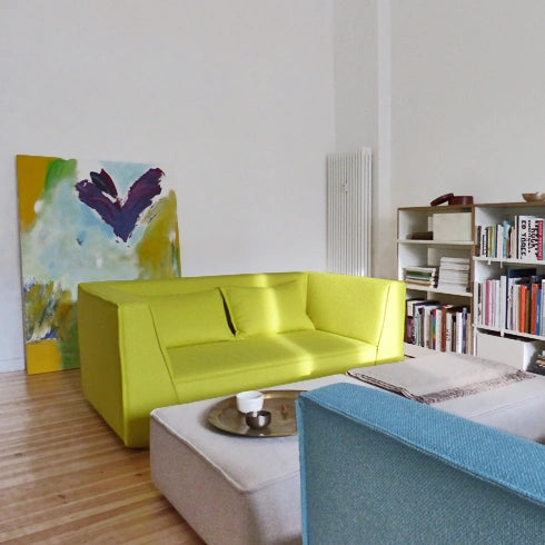 Armchair in bright green, combined with light furniture and stylish decoration.