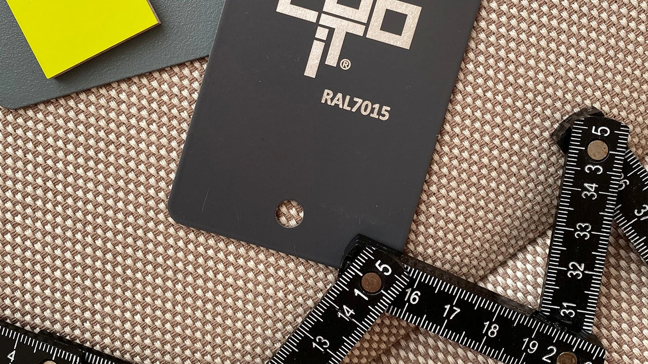 Cubit color sample in RAL7015, a yellow sample, a measuring tape and fabric sample on a beige textile background - symbol for individual planning and material coordination