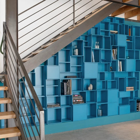 Staircase shelf in blue, modern design, integrated under a wooden staircase.
